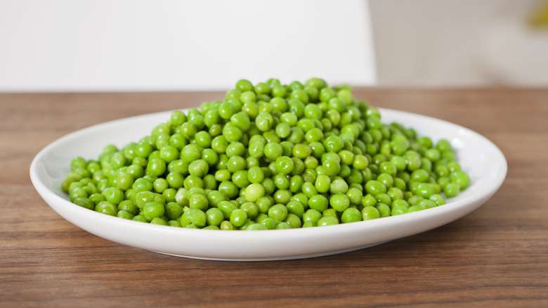 Plate of peas on table