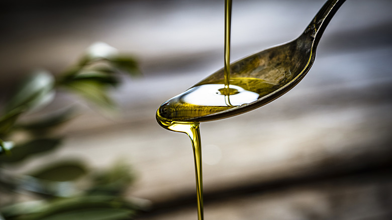 Olive oil pour onto spoon