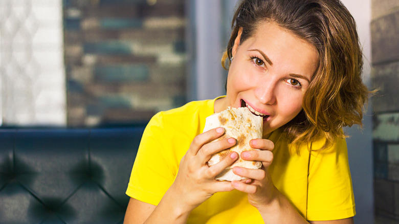 Woman enjoying a pita burger