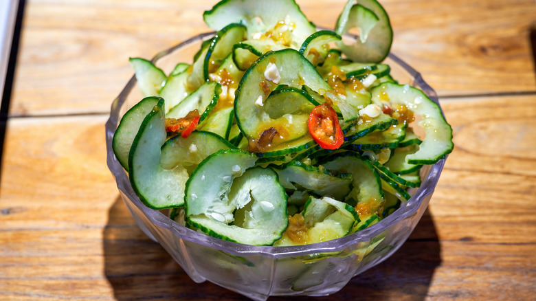 glass bowl of marinated cucumber slices