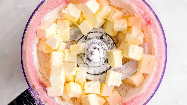 flour and cold butter cubes in a food processor