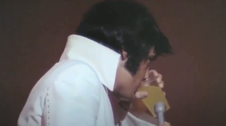 Elvis drinking Gatorade from cup