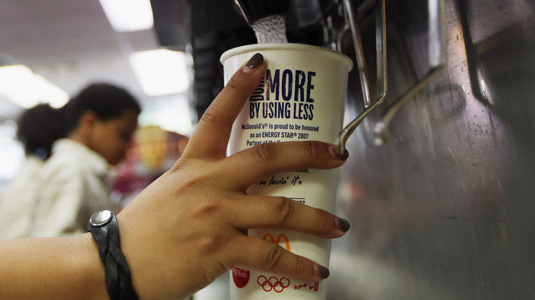 Person filling McDonald's soda cup