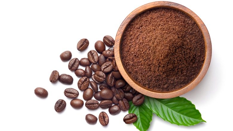 Coffee beans and powder in bowl