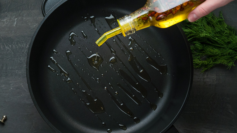 pouring oil into skillet