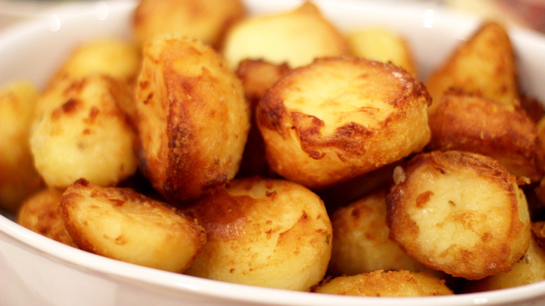 Roasted potatoes in white bowl