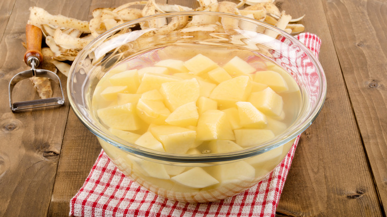 Diced potatoes in bowl of water