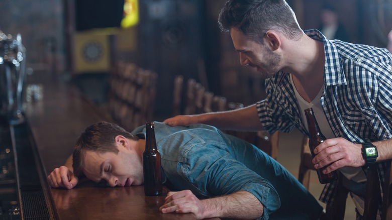 friend picking up buddy at bar