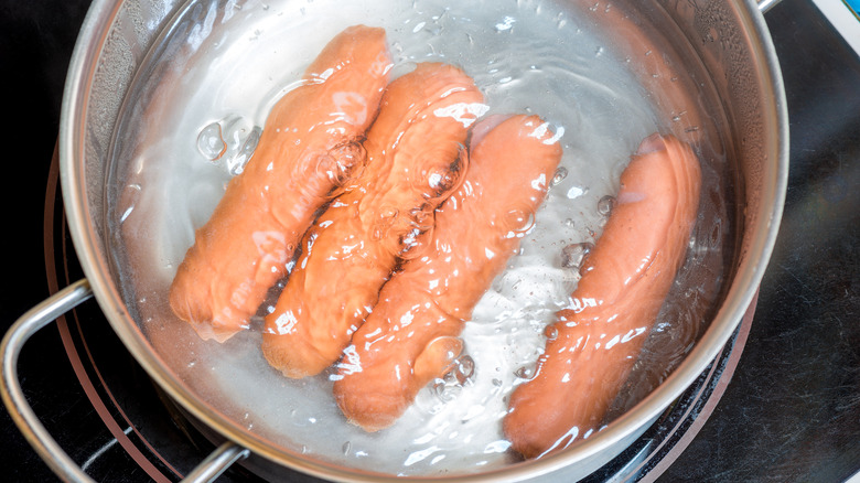 Hot dogs boiling in water