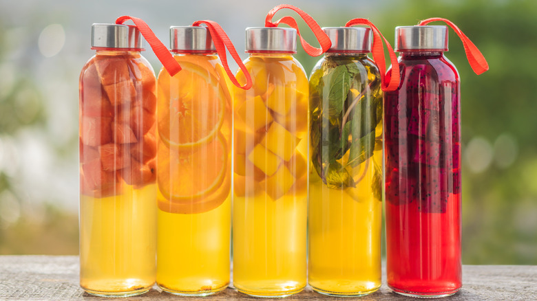 Jars of kombucha with fresh fruit