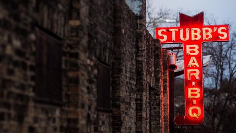 Red lit Stubb's sign brick wall