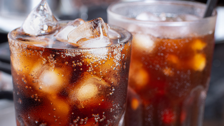 Cola beverages in a glass with ice