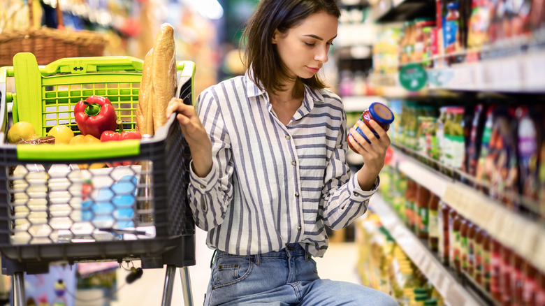 Woman checking expiration date on food product