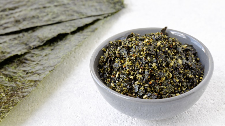 Bowl of homemade furikake with nori sheets on side