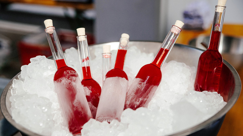 red bottles of liquid in ice bowl