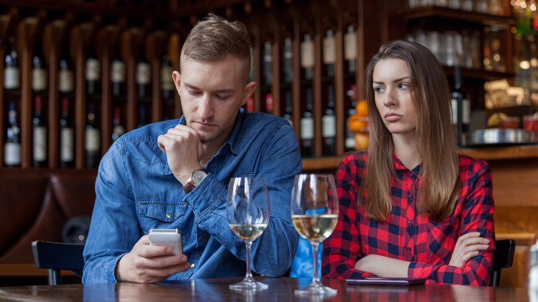 man on phone at restaurant