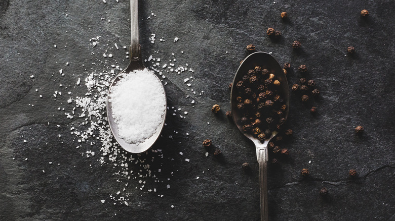 salt and pepper in spoons