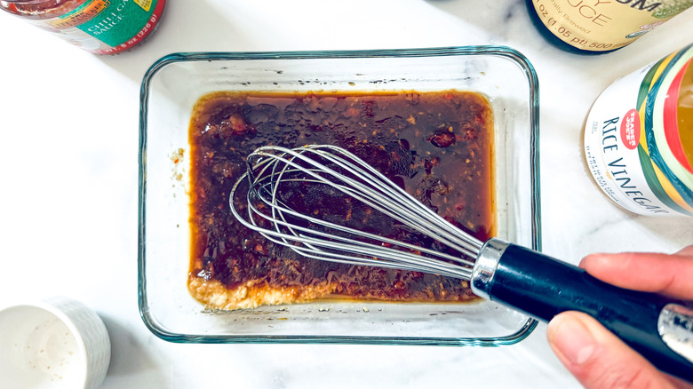 whisking marinade in glass container