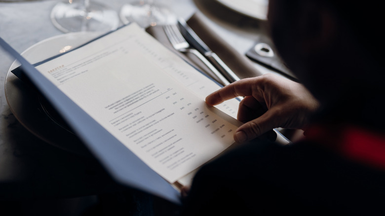Person reading a menu