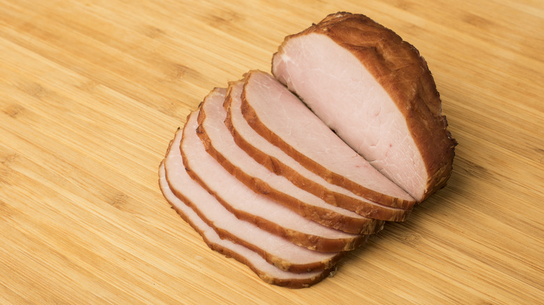 Sliced Canadian bacon on a cutting board