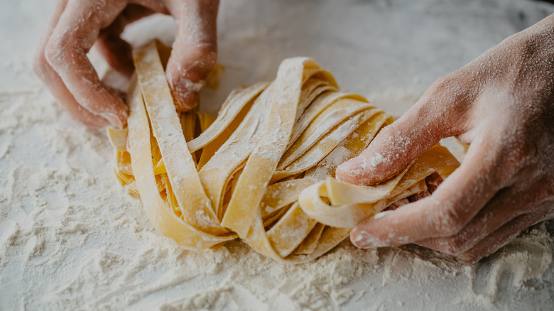 Hands shaping fresh pasta