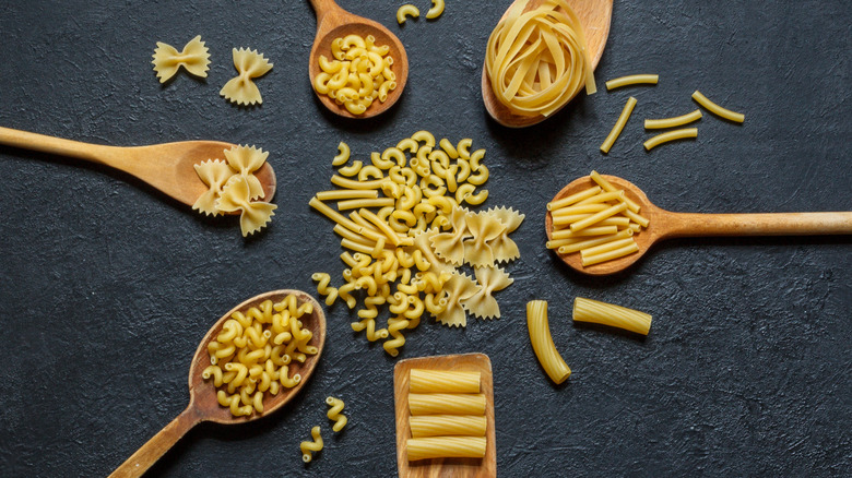 Dry pasta on wooden spoons