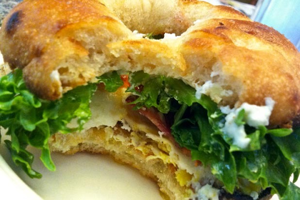 Sunnied Egg Bialy Sandwich with Bacon, Arugula, Goat Cheese, and Balsamic Glaze