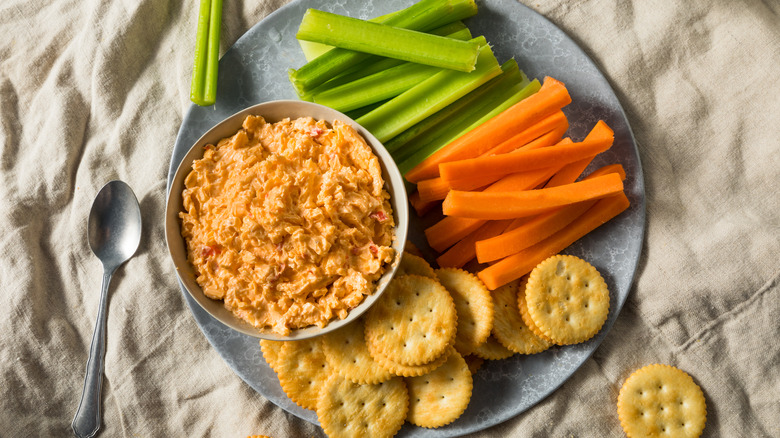 cheese spread with crackers, veggies on plate