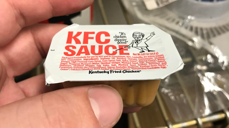 hand holding KFC Sauce cup