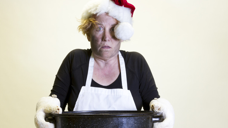 woman in santa hat with black on face from burnt cooking