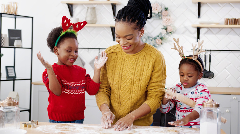 woman baking in kitchen with kids at Christmas