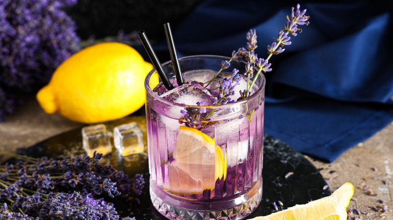 Cocktail garnished with lavender and lemon