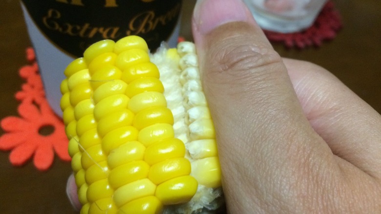 removing corn kernels by hand