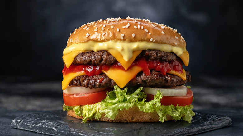 Double cheeseburger on dark background