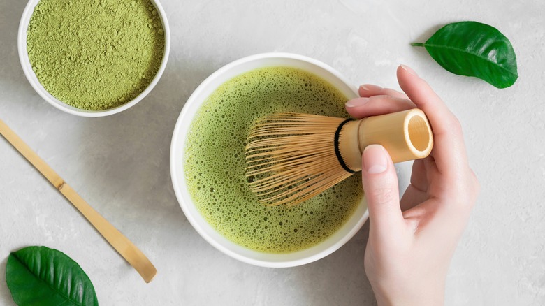 whisking matcha in a bowl