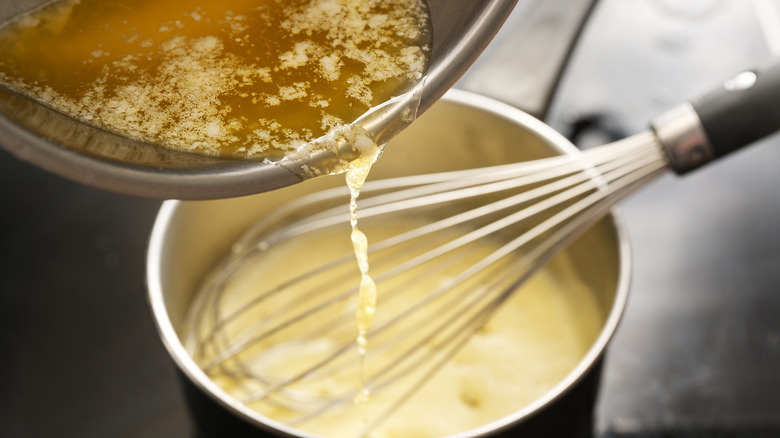 Butter pouring into hollandaise sauce