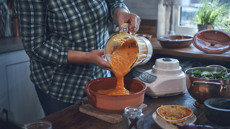 soup being poured from blender