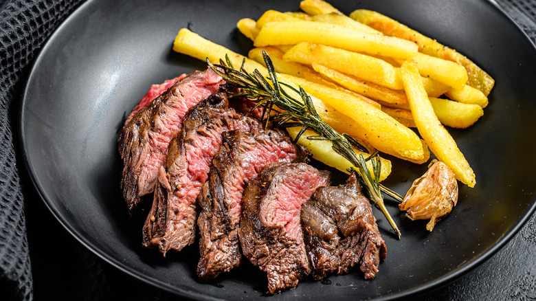 sliced flat iron steak with fries