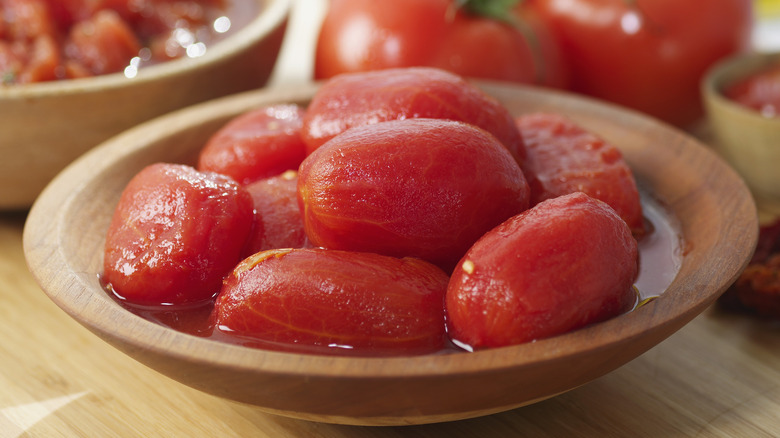 canned tomatoes in wooden bowl