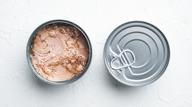 canned tuna on white surface