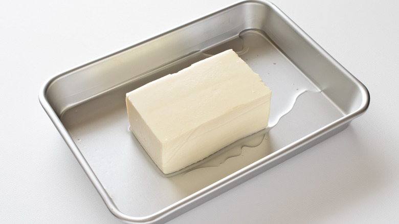 Silken tofu draining on tray