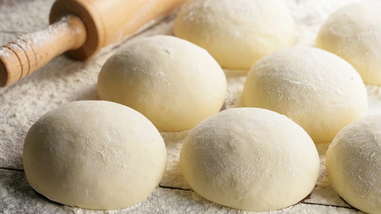 Pizza dough balls on counter