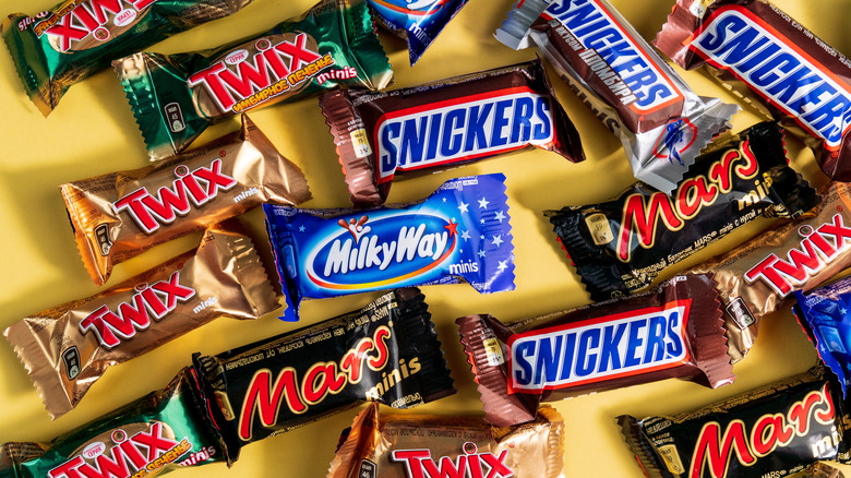 Assortment of mini candy bars on gold background