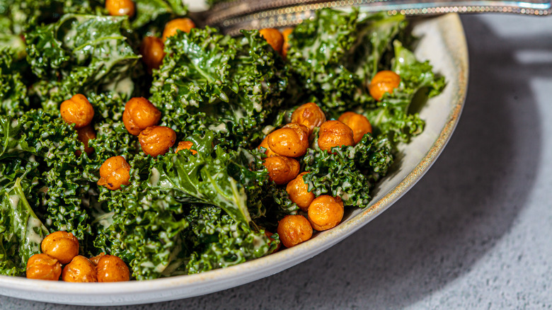 kale caesar salad with chickpeas in dish