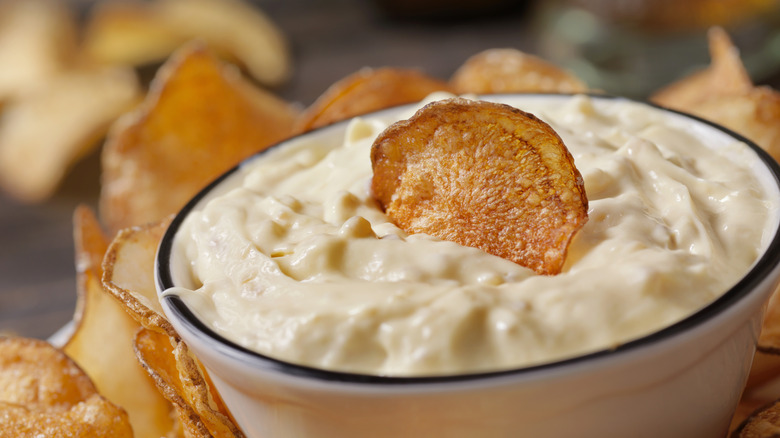 French onion dip in a bowl with a potato chip