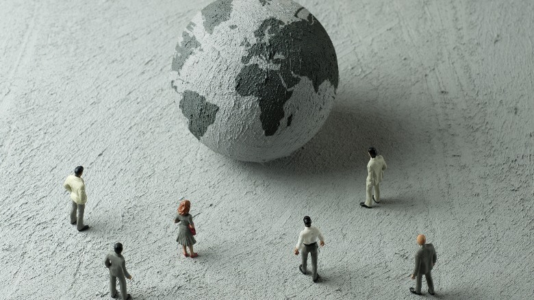 Figurines around a globe