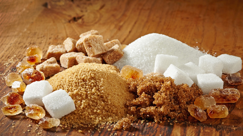 various forms of sugar on wooden table