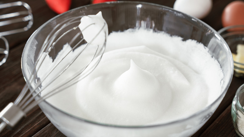 Egg whites whipped to soft peaks in bowl