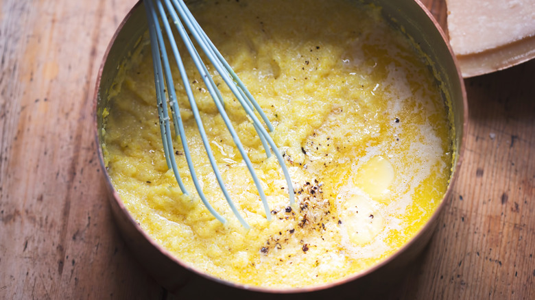 whisking a pot of polenta