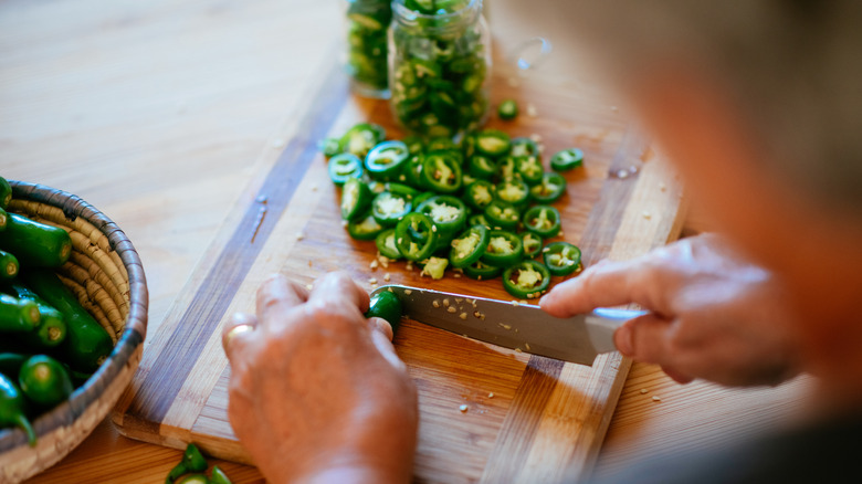 Person chopping jalapeños